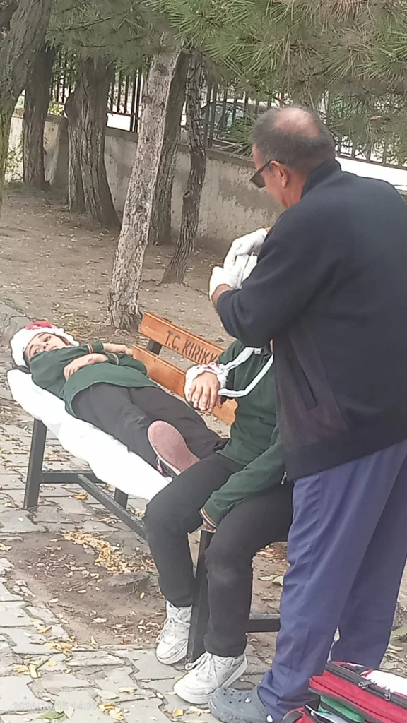 Senaryo kapsamında yaralı rolü verilen öğrencilere ilk müdahale uygulandı.
Tatbikat senaryosunda pansumanlı öğrencilere sağlık görevlisi müdahale uygulaması yapıyor.